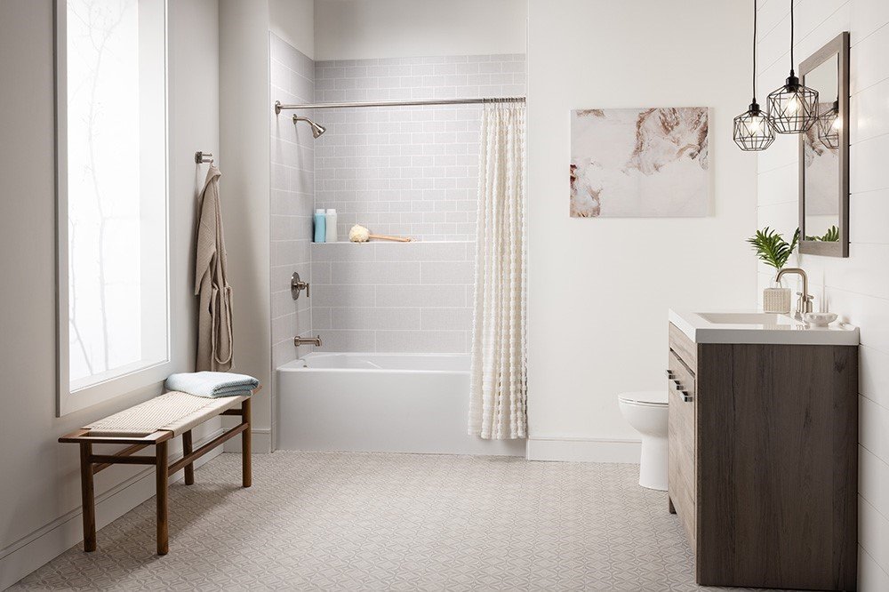 A tub and shower fitted into an existing alcove, with the surround, valve and fittings replaced